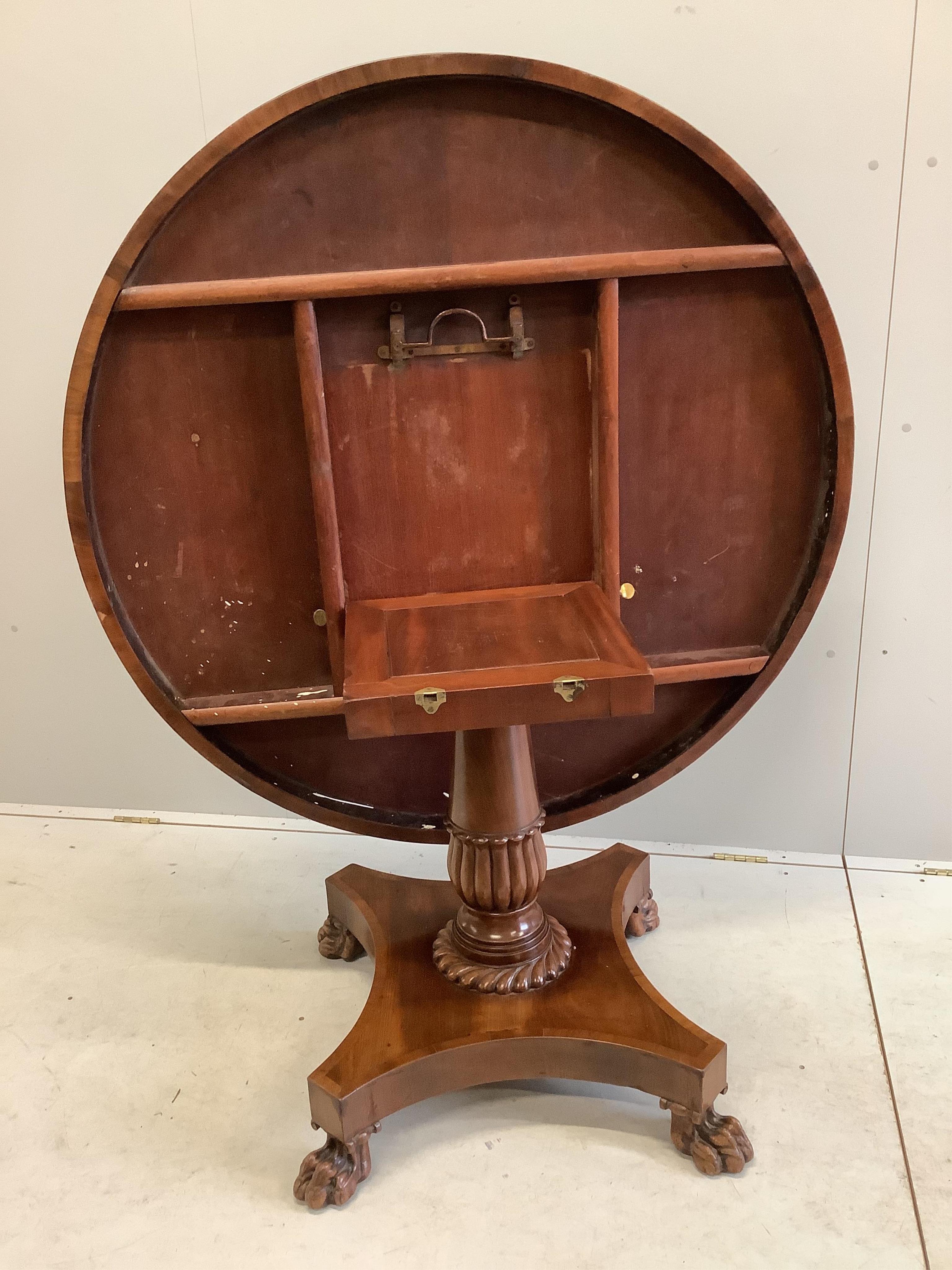 An early Victorian mahogany circular tilt top breakfast table, on a pillar and flat quadruple platform base, diameter 120cm, height 74cm. Condition - good